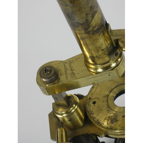 239 - Fred. J. Cox, Eastbourne, a Victorian brass and cast iron microscope, with three different lens, mah... 