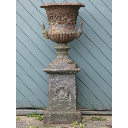 242 - A Victorian good quality pair of cast iron garden urns, twin handle with gadrooned borders and flora... 