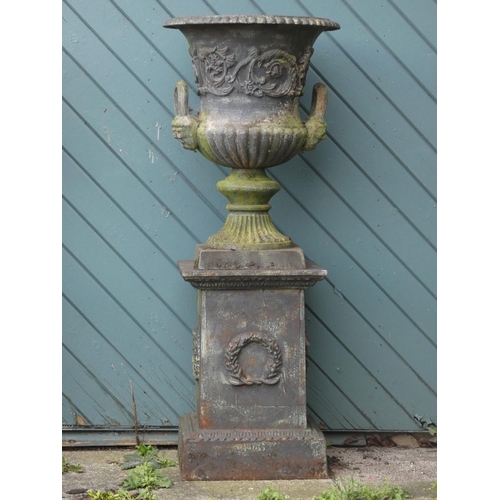 242 - A Victorian good quality pair of cast iron garden urns, twin handle with gadrooned borders and flora... 