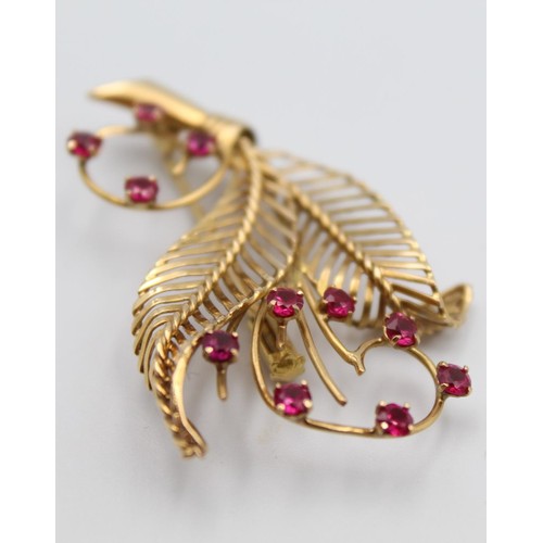 48 - A French gold and synthetic ruby floral spray brooch, bearing control marks, 5 x 3 cm.