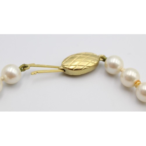 49 - A cultured pearl and lapis lazuli bead necklace, 9ct gold clasp, length 60 cm.