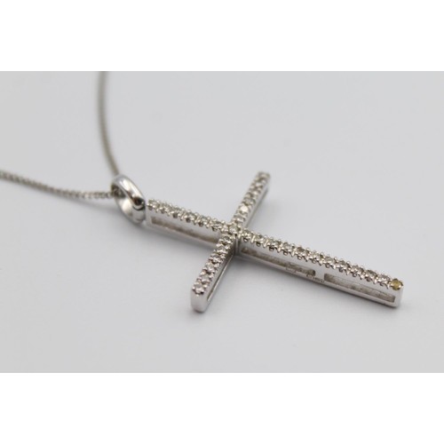 51 - A 9ct white gold diamond cross pendant, claw set with brilliant cut stones, 3 x 2 cm chain, 3gms.