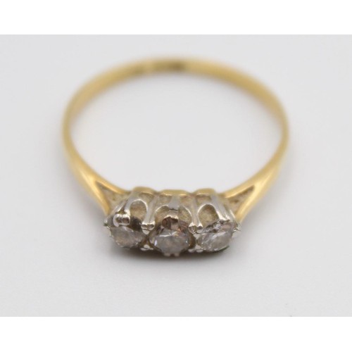 70 - An 18ct gold three stone diamond ring, claw set with brilliant cut stones, total weight approximatel... 