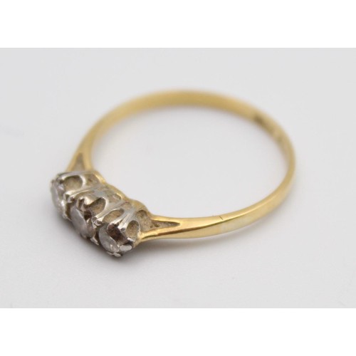 70 - An 18ct gold three stone diamond ring, claw set with brilliant cut stones, total weight approximatel... 