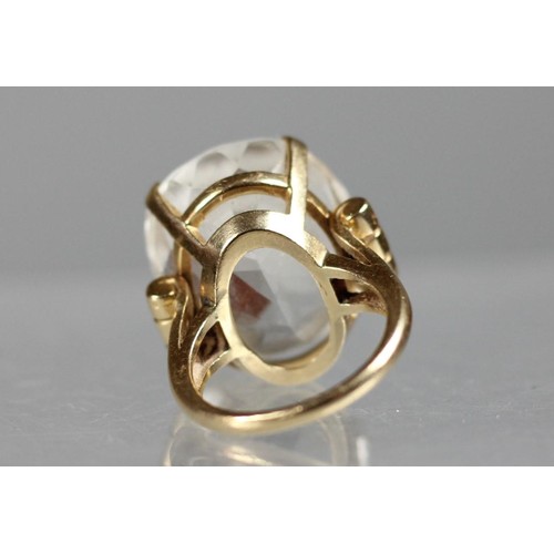 80 - An American 14K gold clear quartz dress ring, claw set with an oval mixed cut stone, 22.0 x 18.8 x 1... 