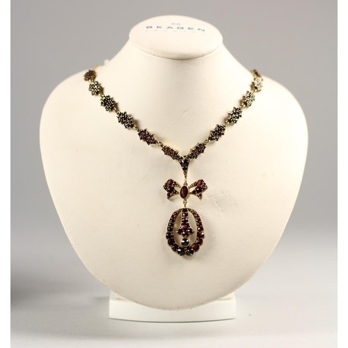 84 - An Austrian silver gilt Bohemian garnet cluster necklace, bearing 900 standard control marks, to a 3... 