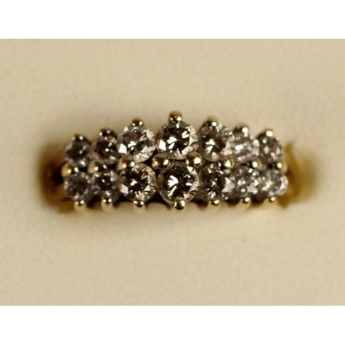 87 - A 14k diamond ring, claw set with two rows of brilliant cut stones, total weight approximately 1 ct,... 