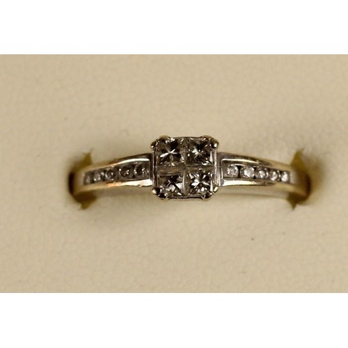 88 - An 18ct white gold diamond ring, claw set with four Princess cut stones, channel set brilliants to t... 