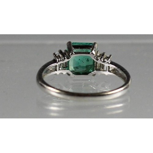 89 - An 18k white gold, emerald and diamond ring, claw set with a step cut stone, stated weight 1.75cts, ... 