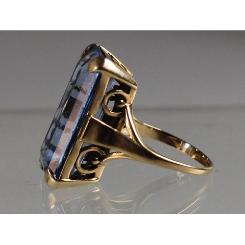 91 - A gold dress ring, claw set with a blue paste stone, size P.