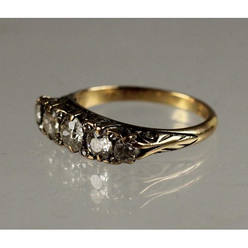 93 - A Victorian 18ct gold five stone diamond ring, carved claw set with graduated stones with points bet... 