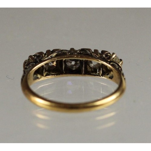 93 - A Victorian 18ct gold five stone diamond ring, carved claw set with graduated stones with points bet... 