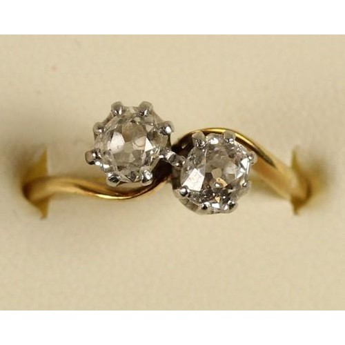 101 - An 18ct gold two stone diamond ring, claw set with old cut stones weighing approximately 0.50cts eac... 