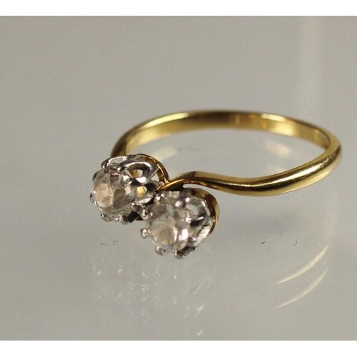 101 - An 18ct gold two stone diamond ring, claw set with old cut stones weighing approximately 0.50cts eac... 