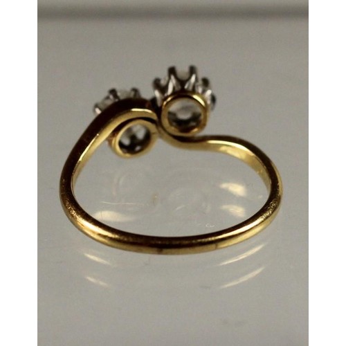 101 - An 18ct gold two stone diamond ring, claw set with old cut stones weighing approximately 0.50cts eac... 