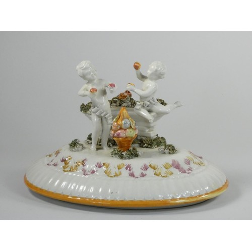 129 - A 19th century continental pedestal dish, the lift off cover with two cherubs and fruit, similar ped... 