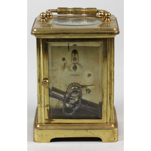 255 - A French brass carriage time piece, the white enamel dial unsigned, the movement stamped Made in Fra... 