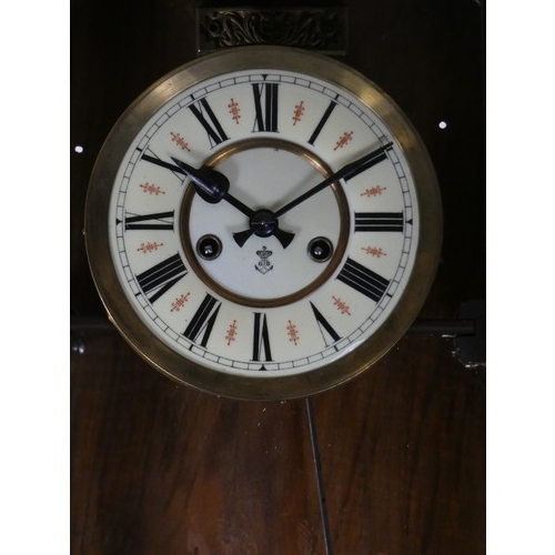 270 - Gustave Becker, a Vienna style walnut wall clock, with turned supports, pendulum, key, 90 cm.