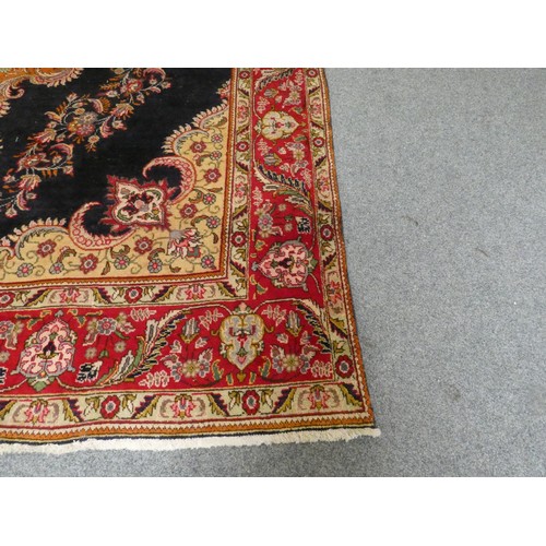 321 - A large Persian wool rug, with a blue field with red foliage border, 390 x 290 cm