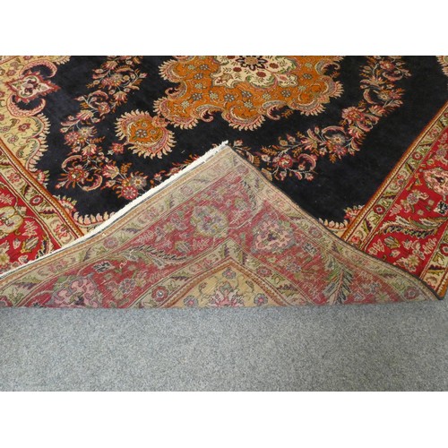 321 - A large Persian wool rug, with a blue field with red foliage border, 390 x 290 cm