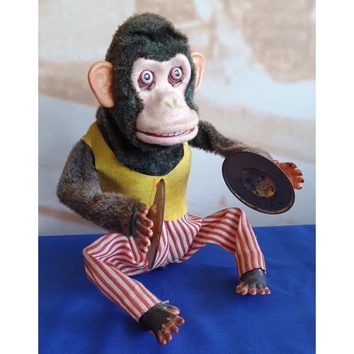 361 - A Japanese battery operated mechanical monkey playing the cymbals, 28 cm.