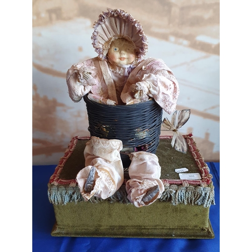 368 - An early 20th Century antique style musical automaton, in the form of a macabre baby doll in basket;... 