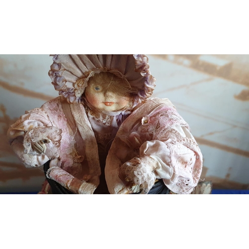 368 - An early 20th Century antique style musical automaton, in the form of a macabre baby doll in basket;... 