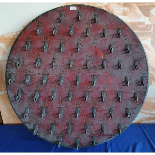 379 - A pianted wood Hoopla board with brass hooks, numbered 12 and 13, diameter 90 cm.