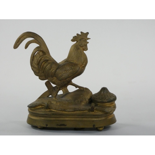 415 - A French gilt metal musical box/desk stand, in the form of a cockerel with inkwell and pen tray, ht ... 