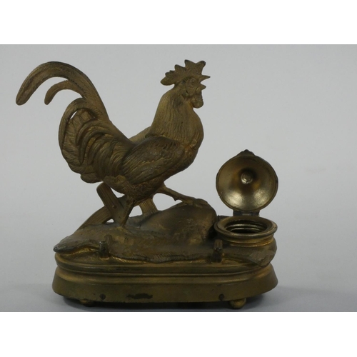 415 - A French gilt metal musical box/desk stand, in the form of a cockerel with inkwell and pen tray, ht ... 