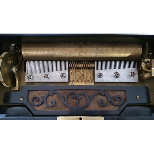 434 - A 19th century Swiss Music box in a burr walnut and ebonised case with 2 cones and central musical s... 