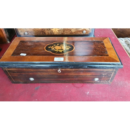 436 - A 19th century Swiss music box in a faux rosewood and boxwood inlaid case, single comb movement numb... 