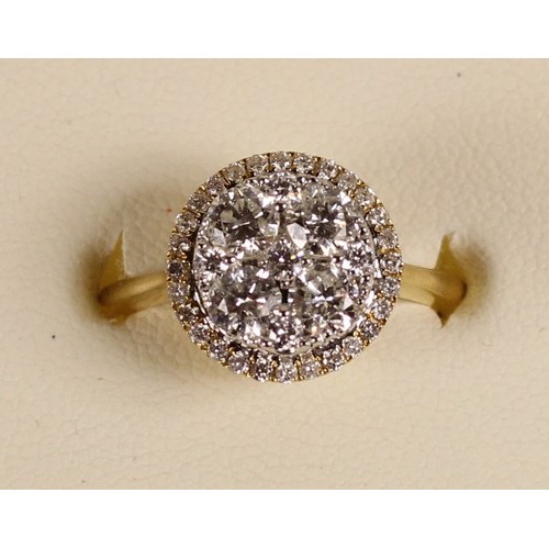 90 - An 18ct gold diamond cluster ring, claw set with brilliant cut stones, bordered by a halo of smaller... 