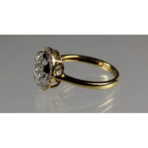 90 - An 18ct gold diamond cluster ring, claw set with brilliant cut stones, bordered by a halo of smaller... 