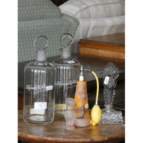 109 - A pair of Elizabeth Arden beauty counter advertising bottles together, with an orange cylindrical gl... 