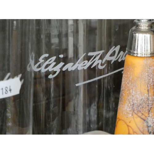 109 - A pair of Elizabeth Arden beauty counter advertising bottles together, with an orange cylindrical gl... 