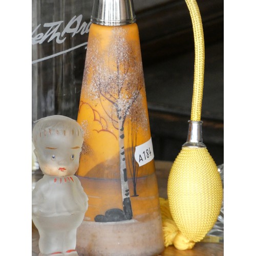 109 - A pair of Elizabeth Arden beauty counter advertising bottles together, with an orange cylindrical gl... 