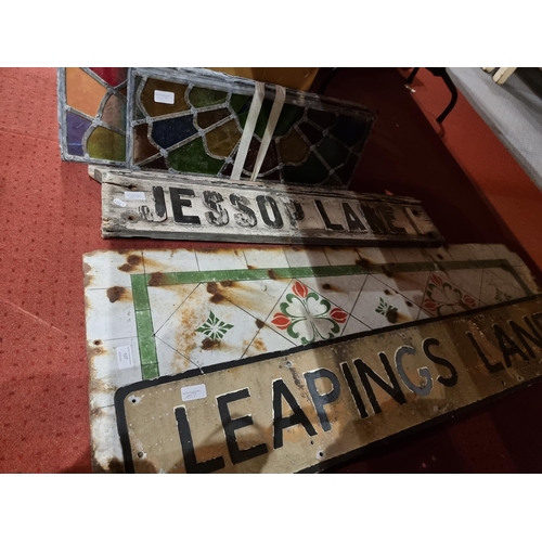 107 - Four stained glass panels 49x22 cm together, with an enameled panel 123x38 cm, a aluminum street sig... 