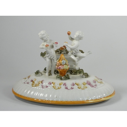 111 - A 19th century continental pedestal dish, the lift off cover with two cherubs and fruit, similar ped... 