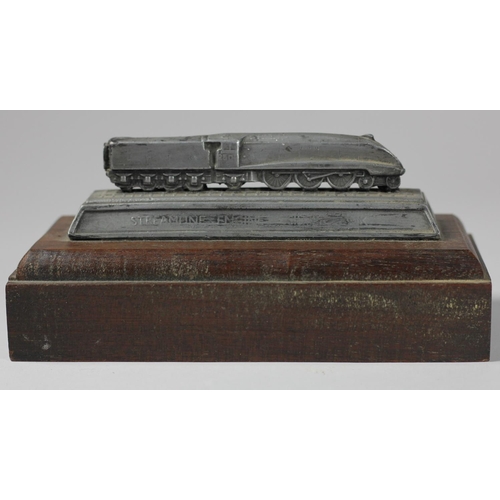 104 - An official LNER streamline engine silver link pewter paperweight on a hardwood plinth issued by LNE... 