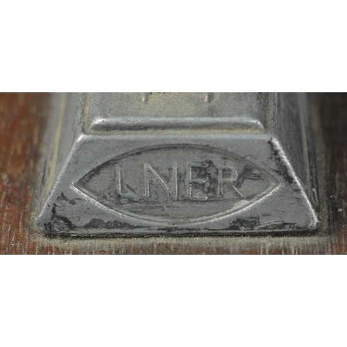 104 - An official LNER streamline engine silver link pewter paperweight on a hardwood plinth issued by LNE... 