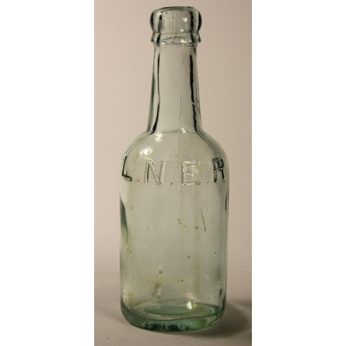 108 - Two 1/2 pint railway beer bottles, G.C.R green glass, LNER clear glass, both stamped with railway in... 