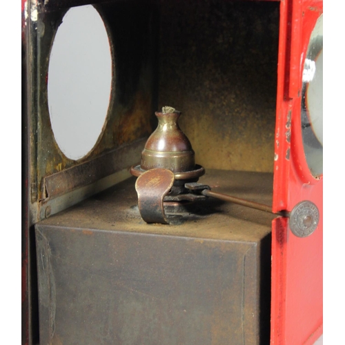 196 - A large red unmarked signal lamp, complete with burner