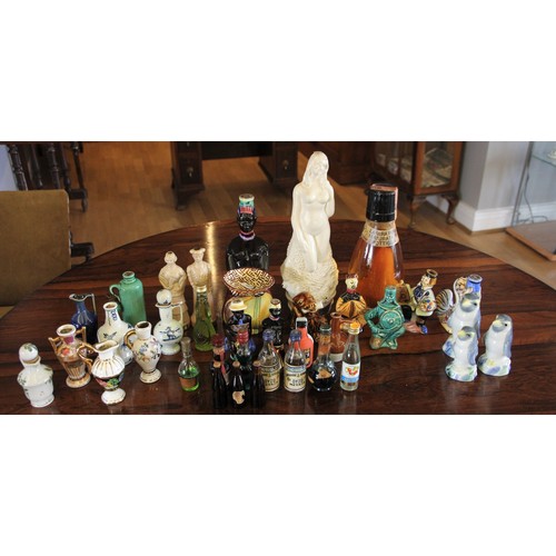 38 - A collection of miniature decanters together with a plated canteen of cutlery, brass bell, binocular... 