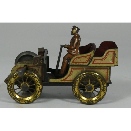 182 - An early 20th century tin plate model of a car & driver.