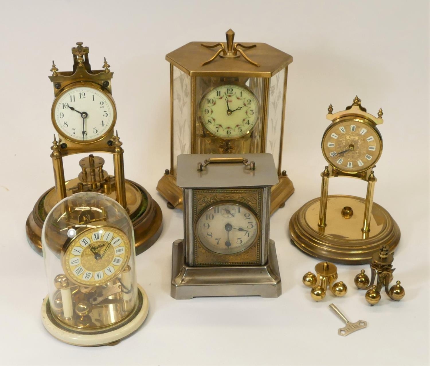 A collection of clocks to include, manual wind anniversary clocks and a