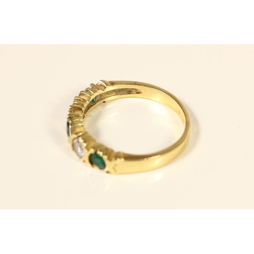 73 - A French 14ct gold emerald and white stone five stone ring, set with brilliant cut stones, bearing c... 