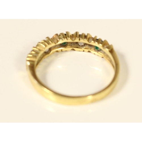 73 - A French 14ct gold emerald and white stone five stone ring, set with brilliant cut stones, bearing c... 