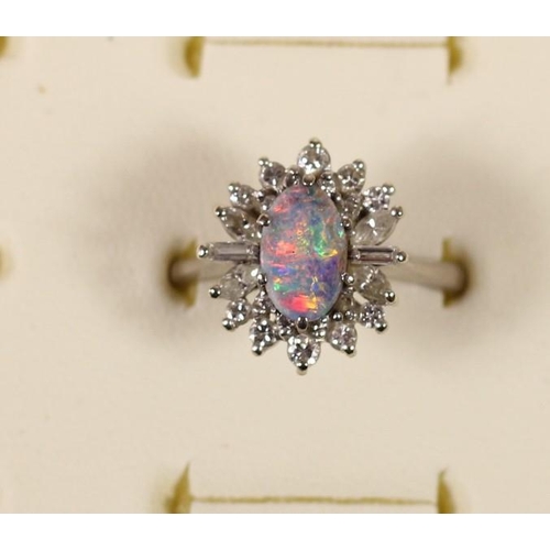 74 - An 18ct white gold black opal doublet and diamond cluster ring, London 1973, claw set with brilliant... 