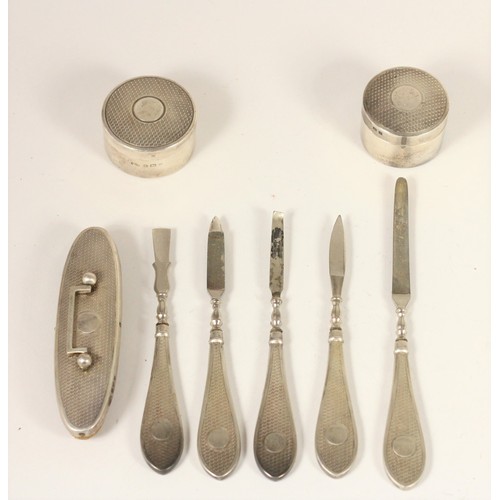 30 - A silver manicure set, Birmingham 1925/6, with engine turned decoration, lacking scissors and two ot... 